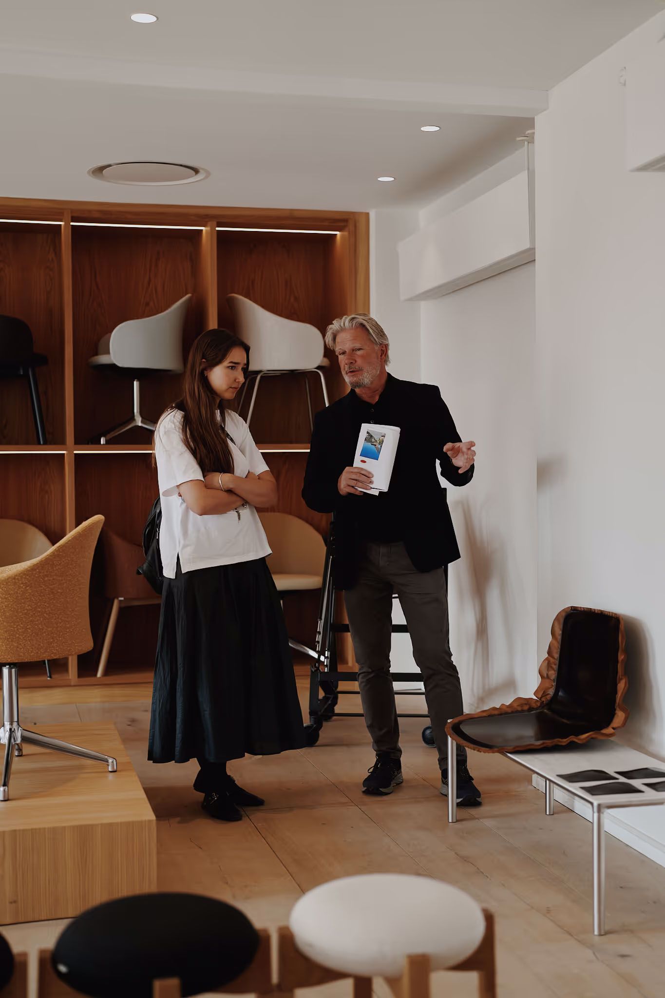 Image may contain Adult Person Chair Furniture Accessories Bag Handbag Clothing Coat and People