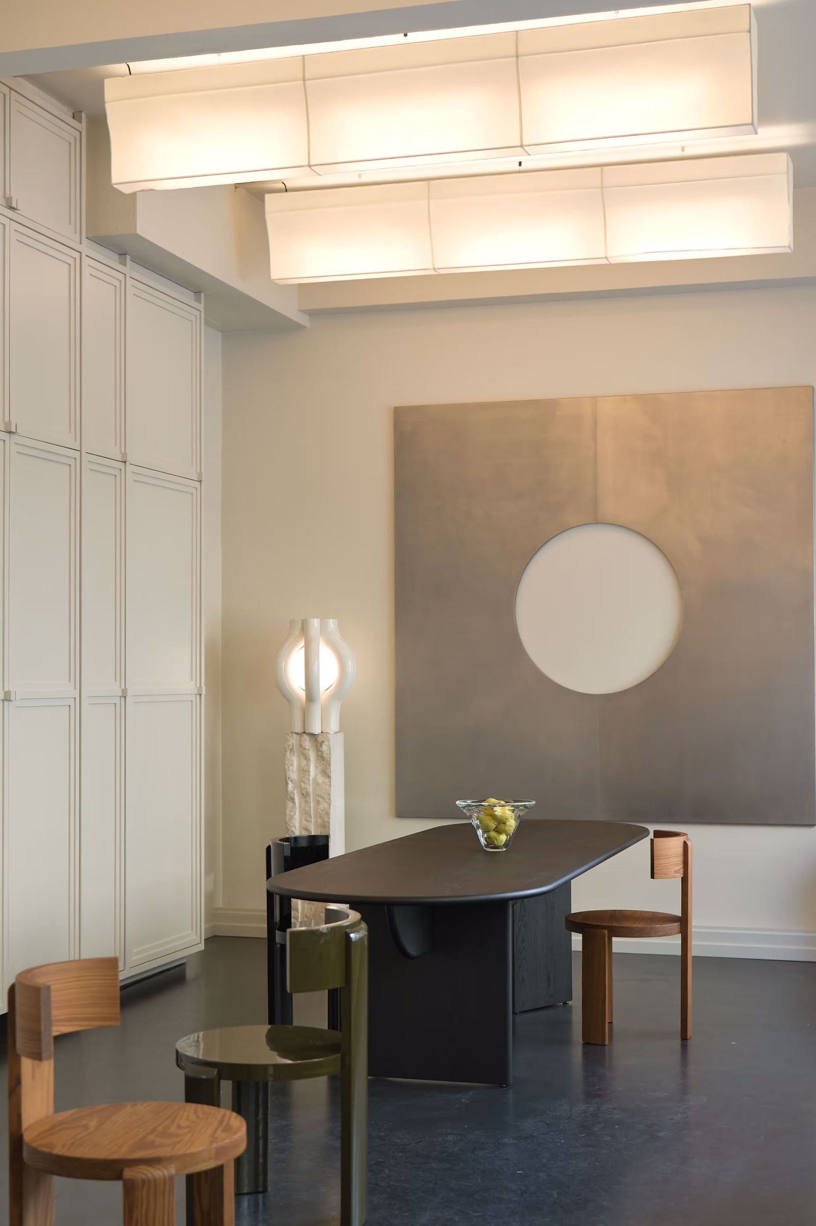 Image may contain Lighting Furniture Table Ceiling Light Indoors Interior Design Lamp Light Fixture and Chair