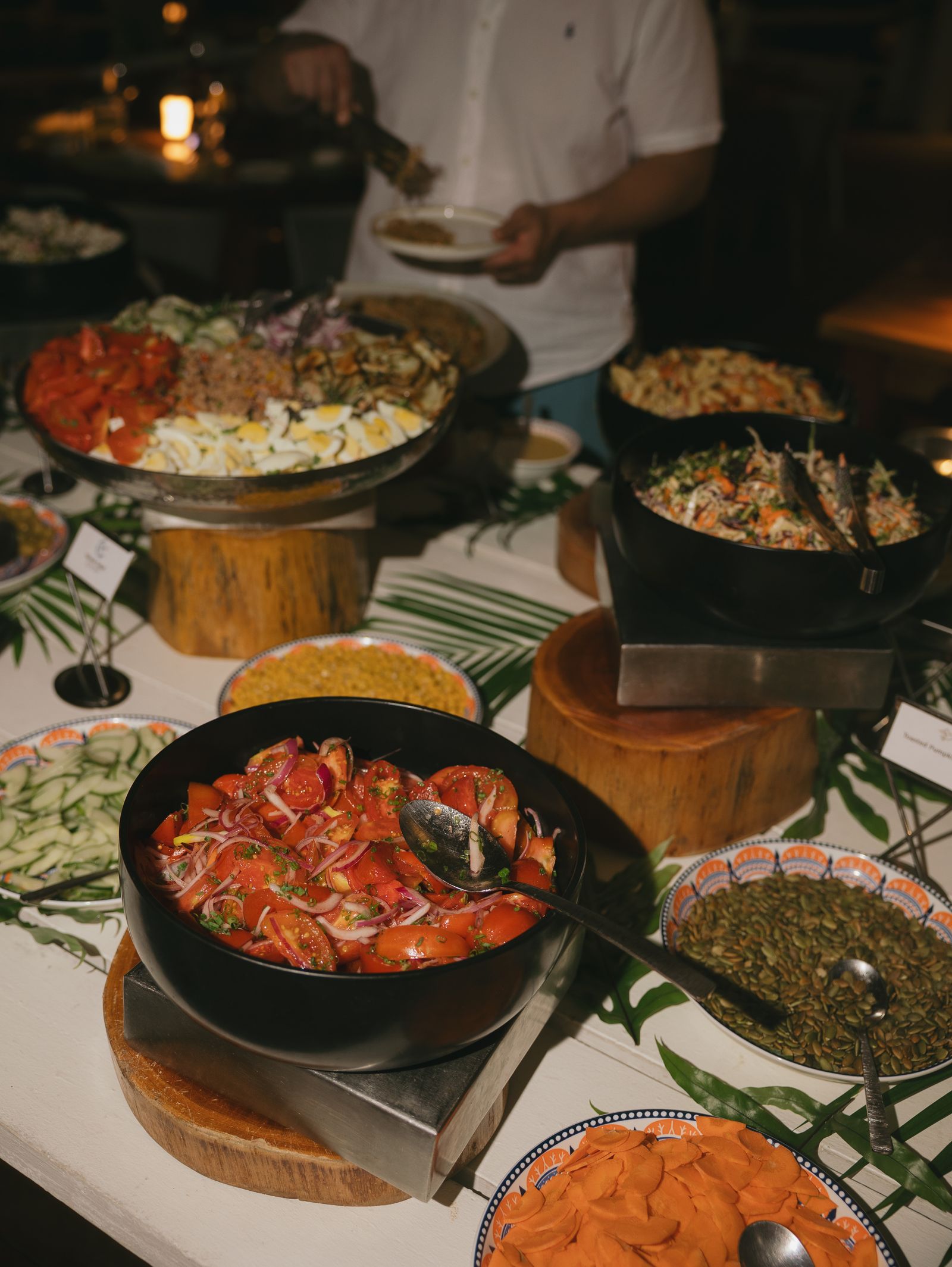 Image may contain Food Food Presentation Adult Person Cutlery Spoon Plate Cookware Pot and Pizza