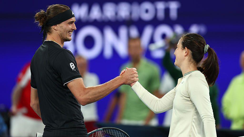 Alexander Zverev shakes hands with Joanna Garland after losing to the 117th-ranked women's player