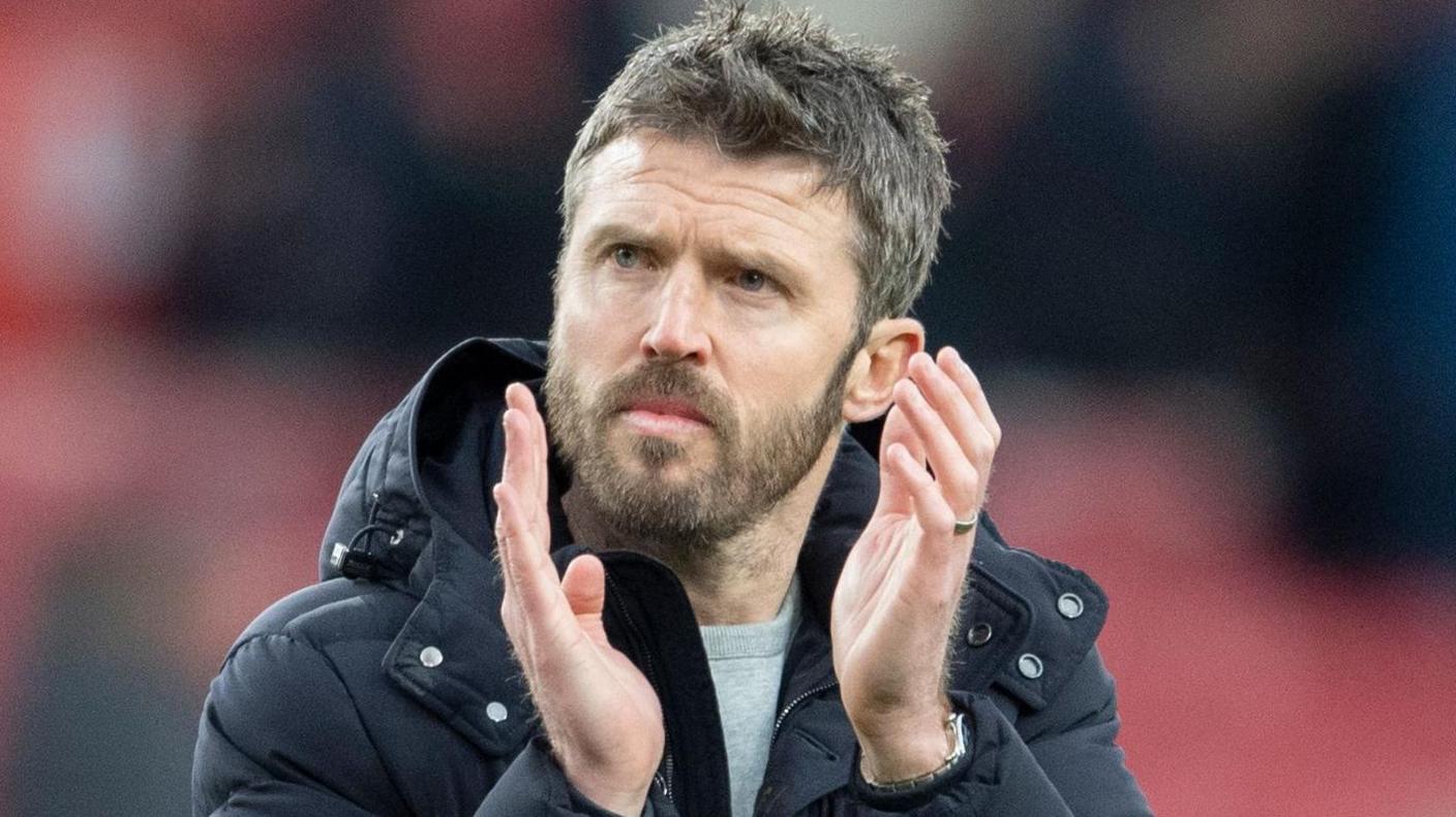 Michael Carrick applauds fans during his team in charge of Middlesbrough