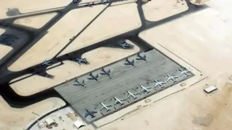 TSGT Scott Reed, USAF In an aerial image of the Al-Udeid air base, a series of planes are seen on the tarmac, which is surrounded by desert.