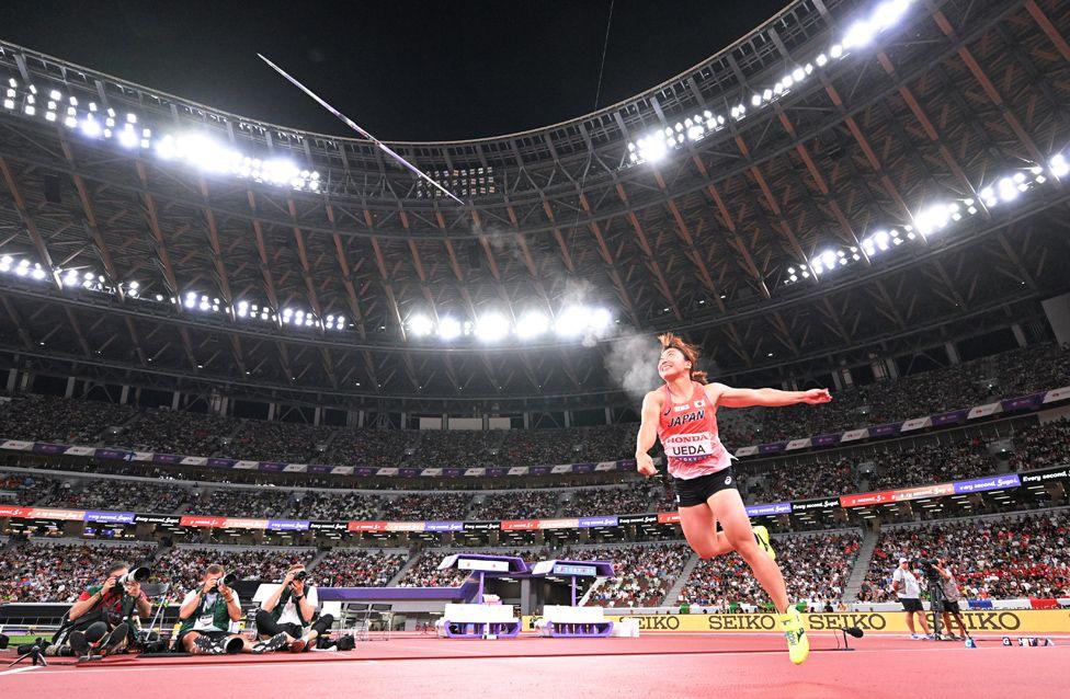 Japanese Javelin Thrower, Momone Ueda, launches a javelin into the Tokyo sky during the 2025 World Athletics Championships while thousands of spectators watch on.