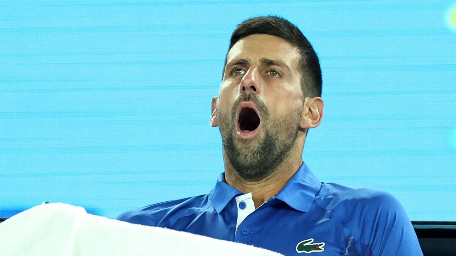 Novak Djokovic yawns during a 2024 Australian Open match