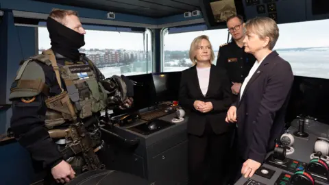 PA Media Foreign Secretary Yvette Cooper meets crew on board the Coast Guard ship K/V Turva in Helsinki which patrols the Finnish coastline and is speaking to a Finnish Coast Guard officer