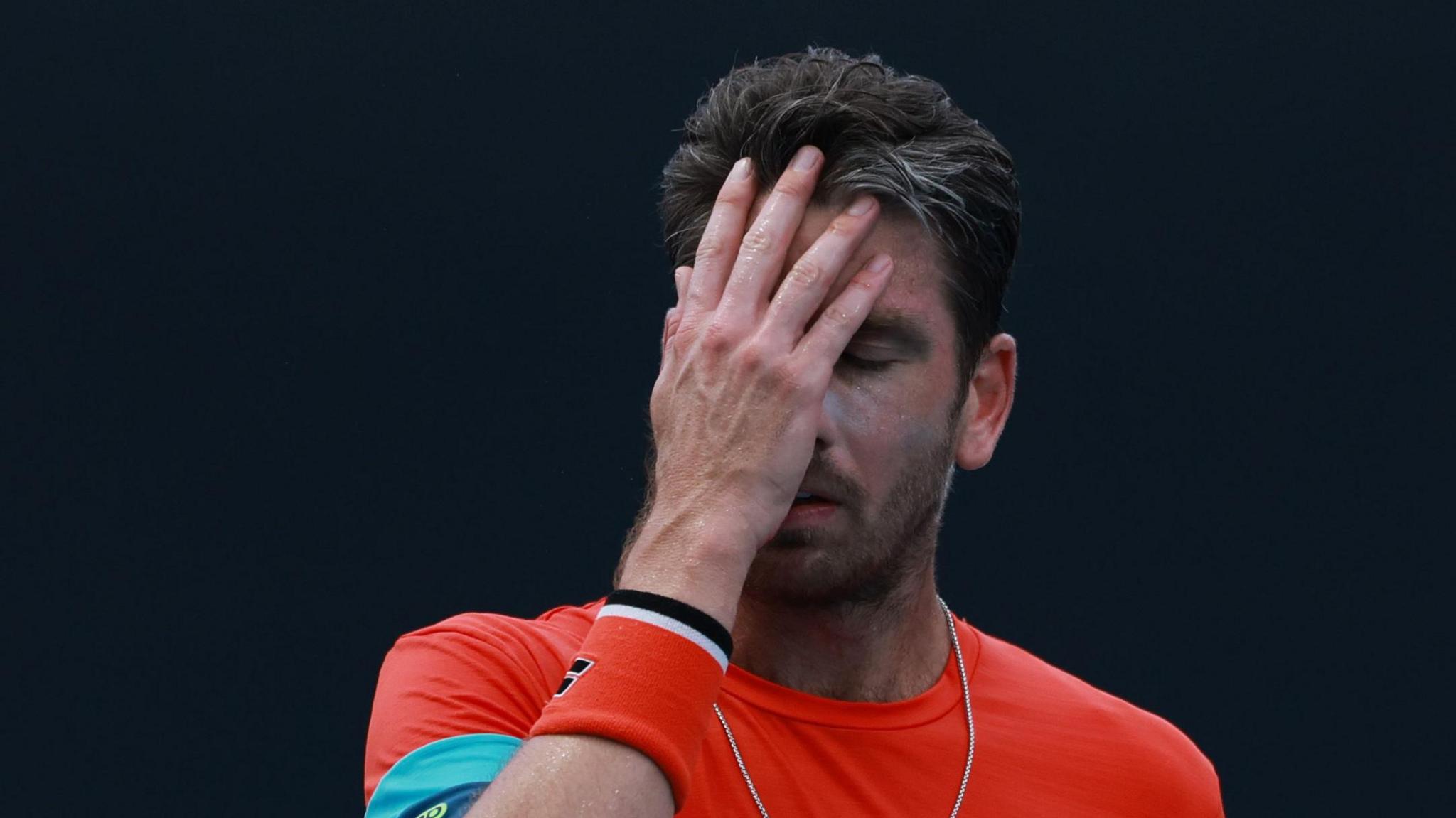 Cameron Norrie facepalms during an Australian Open match
