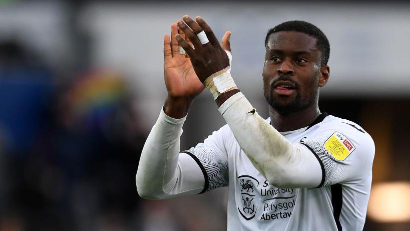 Guehi claps the fans after playing for Swansea in 2021