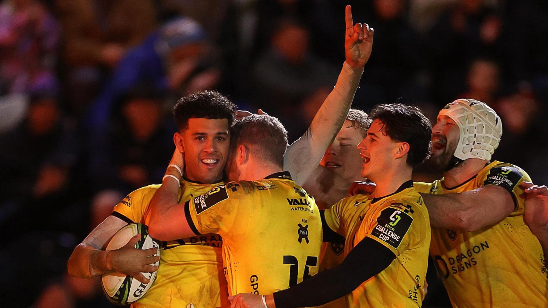 Rio Dyer celebrates with his Dragons teammates after scoring against Newcastle