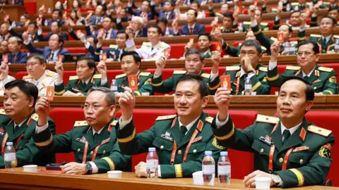 EPA A handout photo made available by Vietnam News Agency shows delegates holding Party ID cards during the 14th National Congress of the Communist Party of Vietnam at the National Convention Centre in Hanoi, Vietnam, 22 January 2026.