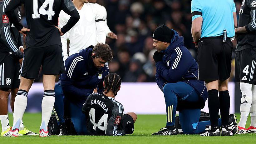 Aston Villa midfielder Boubacar Kamara receives treatment during the FA Cup game against Tottenham on 10 January 2026