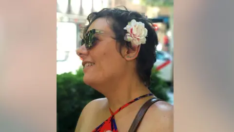 Social Media A woman with a flower in her hair and wearing sunglasses