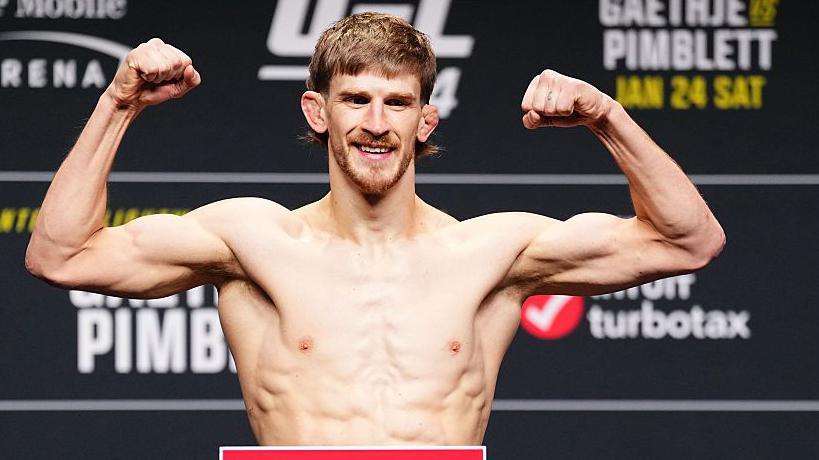 Arnold Allen smiles as he weighs in