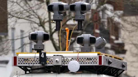 PA Media Live facial recognition cameras sit on top of a police van in Croydon.