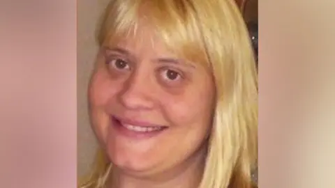 Surrey Police Dawn Rhodes is seen in a close-up photograph with long, blonde hair.