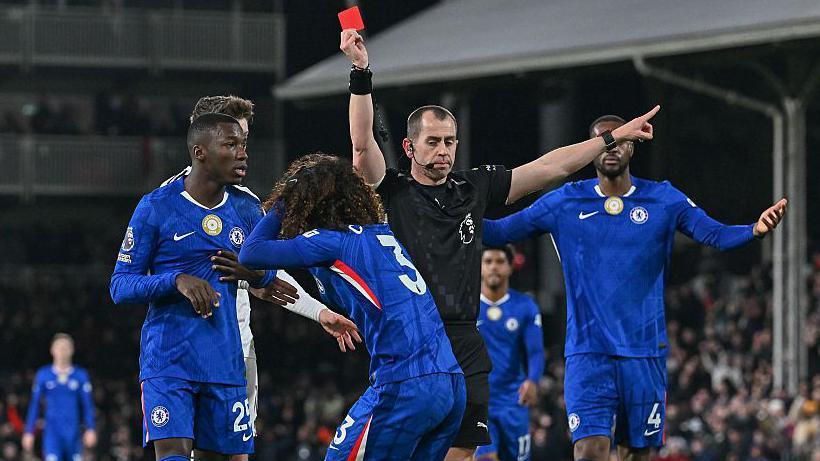 Marc Cucurella of Chelsea is shown the red card by referee Peter Bankes