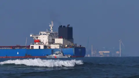 Reuters A French navy boat surrounds the GRINCH oil tanker, intercepted by France in the Alboran Sea on suspicion of operating under a false flag and belonging to Russia's shadow fleet