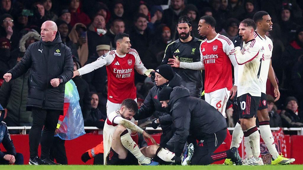 Conor Bradley receives treatment as Gabriel Martinelli protests