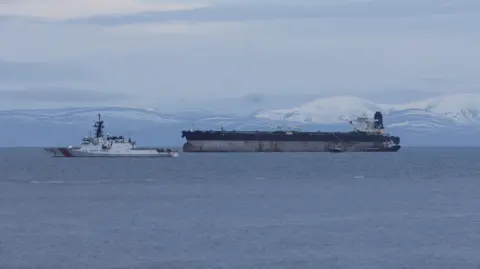 Reuters Oil tanker Marinera, previously known as Bella 1, which was seized by the U.S. Coast Guard last week, is moored next to a U.S. Coast Guard vessel in the Moray Firth,