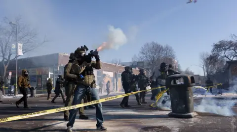 Reuters A federal agent fires a munition toward demonstrators near the site where a man identified