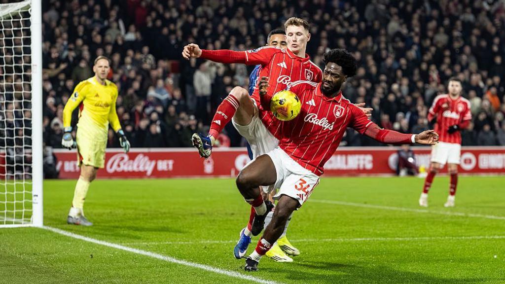 Nottingham Forest defender Ola Aina appears to control the ball with his arm inside the penalty area
