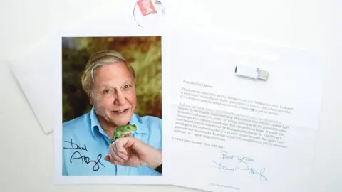 Christian Marot A signed photograph of Sir David Attenborough is displayed next to a letter of congratulations from him, saying he had enjoyed the Madagascar film very much which was a truly remarkable achievement to have shot in just six weeks with some helpful pointers