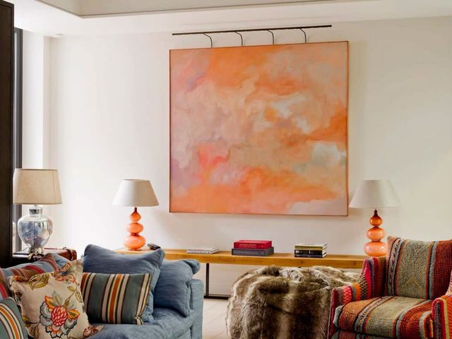 Image may contain: Lamp, Book, Publication, Art, Painting, Home Decor, Couch, and Furniture