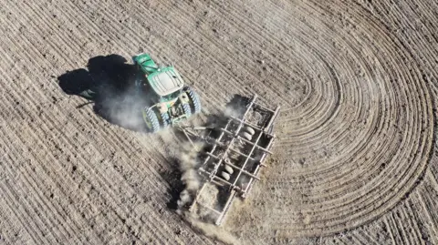 Getty Images An aerial view of a farmer plowing a field in Colorado.