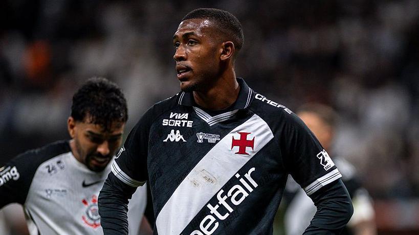 Rayan looking while stood on the pitch with his hands on his hips