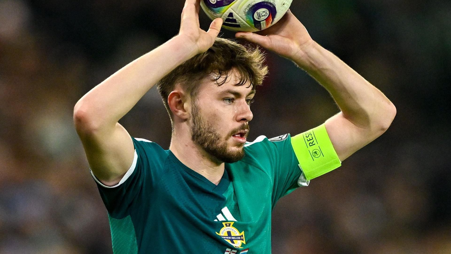 Conor Bradley takes a throw in