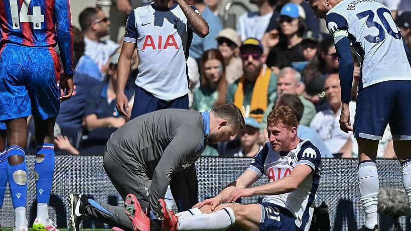 Tottenham forward Dejan Kulusevki receives treatment after sustaining an injury during the Premier League game against Crystal Palace in May 2025