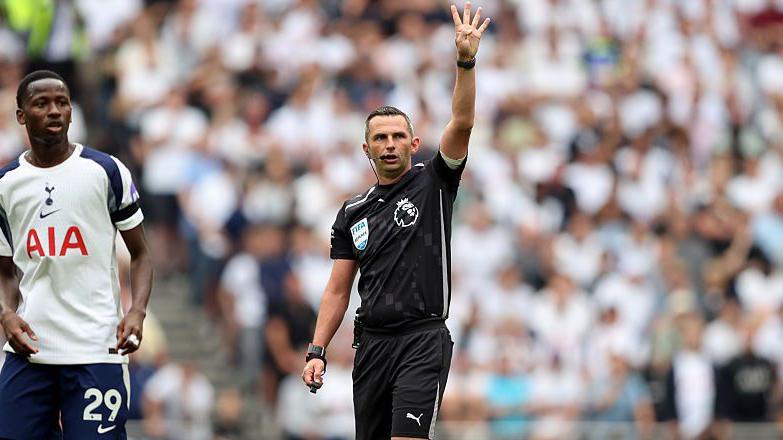 Michael Oliver indicates the eight second countdown to a goalkeeper during the Premier League match between Tottenham Hotspur and Burnley