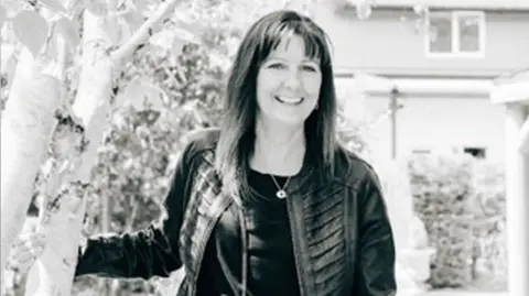 Family A black and white image of a woman in a black leather jacket, with long dark hair