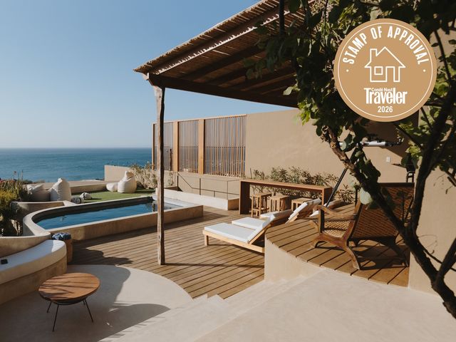 Image may contain: Tub, Architecture, Building, House, Housing, Porch, Hot Tub, Deck, Chair, Furniture, Terrace, and Indoors