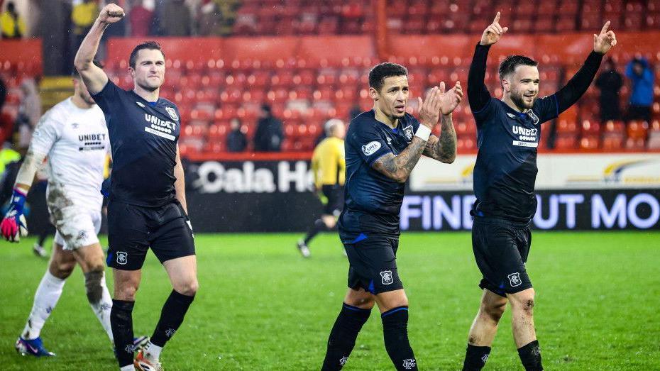 Rangers players salute their fans at Pittodrie