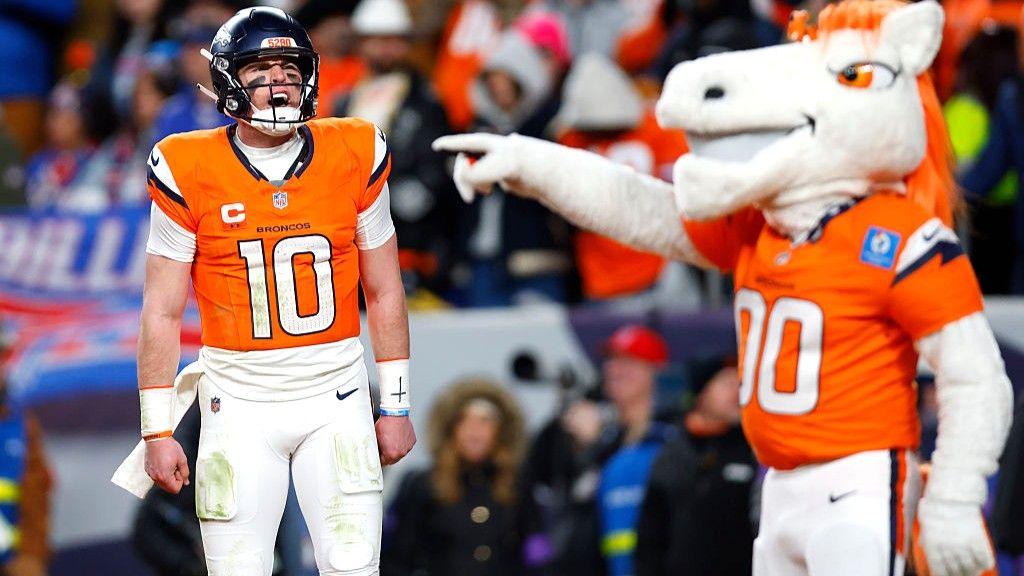 Denver Broncos mascot points at Bo Nix