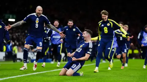 PA Media Kenny McLean celebrates sending Scotland to the 2026 World Cup with a win over Denmark.