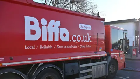 Getty Images A red lorry with Biffa.co.uk on the side in white writing.