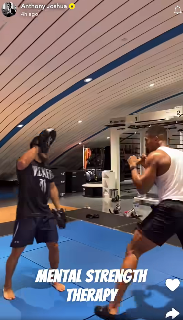 Still image from Anthony Joshua video showing him back in the gym with caption 'mental strength therapy'