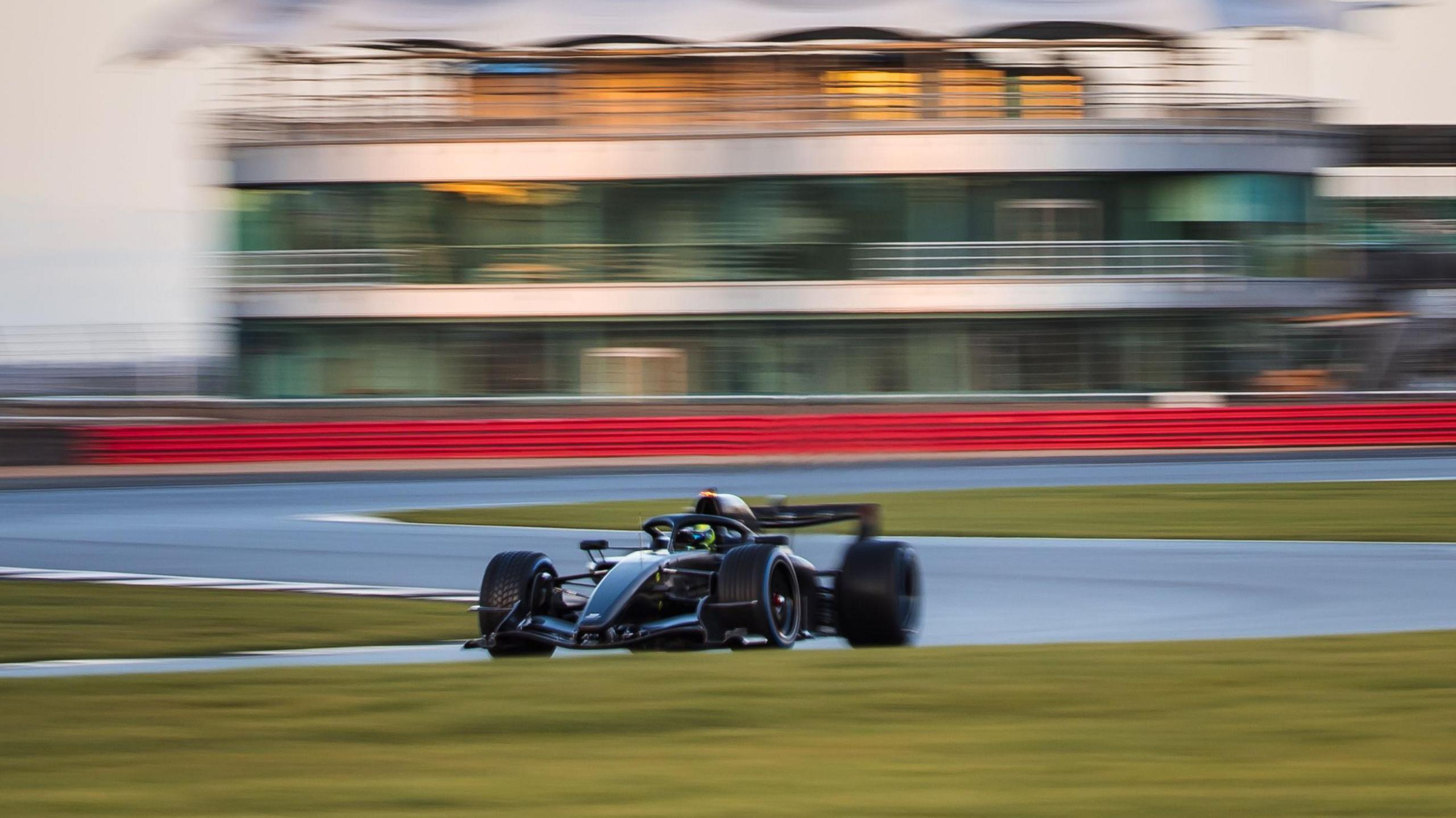 The Cadillac F1 car at Silverstone with the British Racing Drivers' Club clubhouse behind