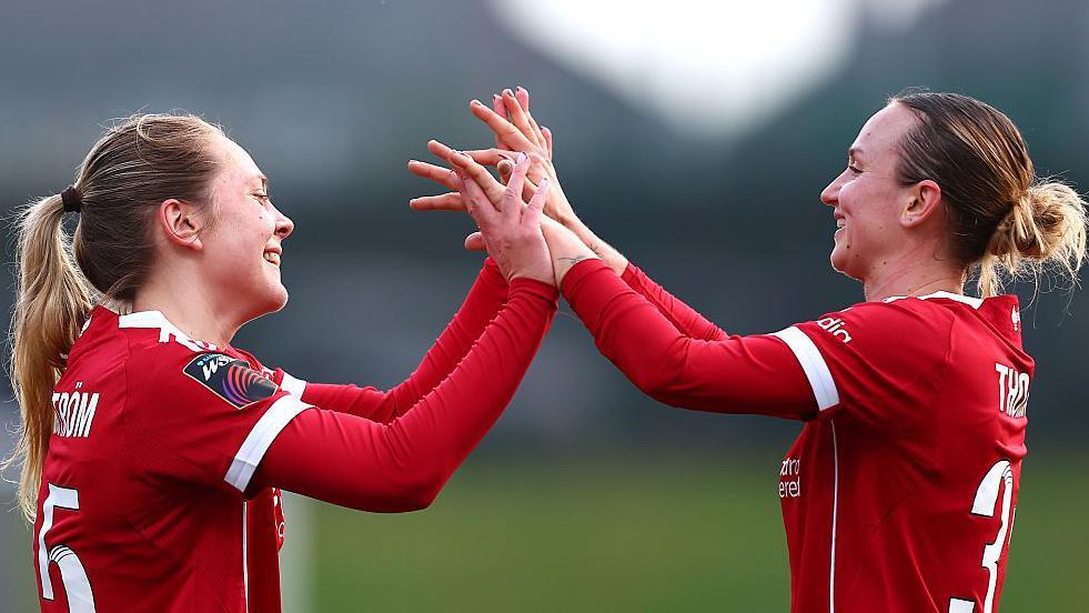 Alice Bergstrom of Liverpool celebrates scoring her team's sixth goal with teammate Martha Thomas