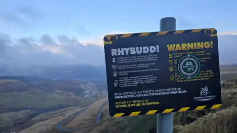 Nathan Dixon A no fly tipping sign on the mountain