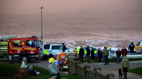 Darrin Stevens Picture of a fire engine, police car and emergency workers on the seafront in Withernsea.