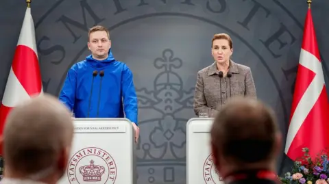 Reuters Greenland's Prime Minister, Jens-Frederik Nielsen and Denmark's Prime Minister Mette Frederiksen standing side-by-side at two separate lecterns with microphones during a press conference in Copenhagen, Denmark.