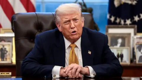 Reuters Trump at his Oval Office desk