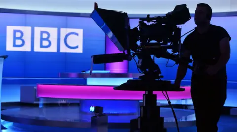 A BBC camera operator in a BBC studio