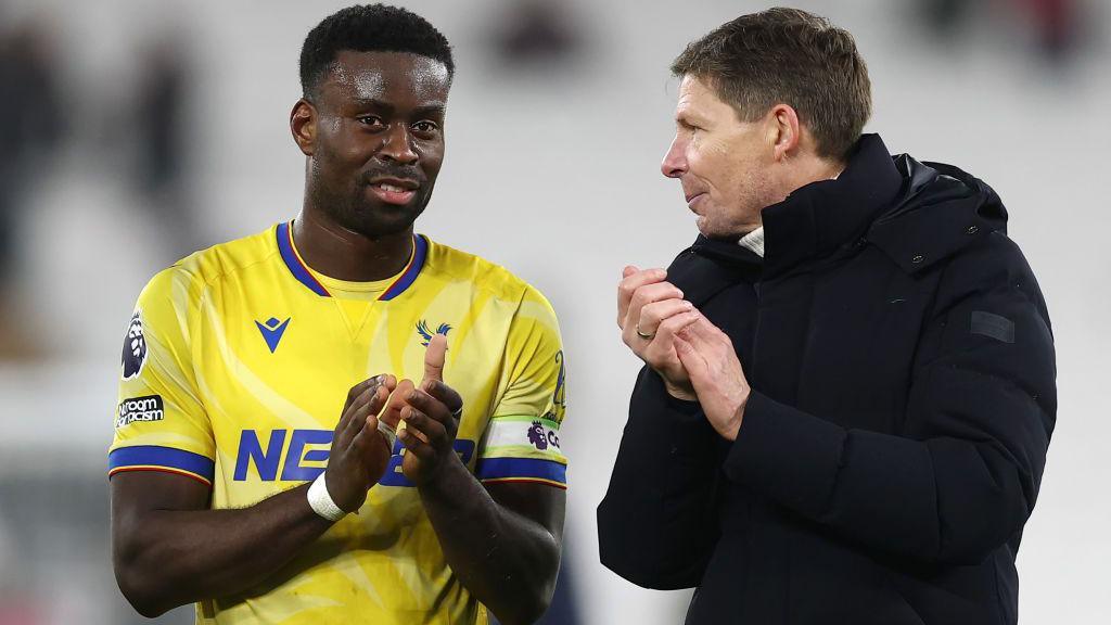 Marc Guehi and Oliver Glasner stand together at full time after Crystal Palace's game with West Ham