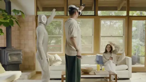 1X NEO the bot with a human wearing a VR headset. The robot follows how the human moves