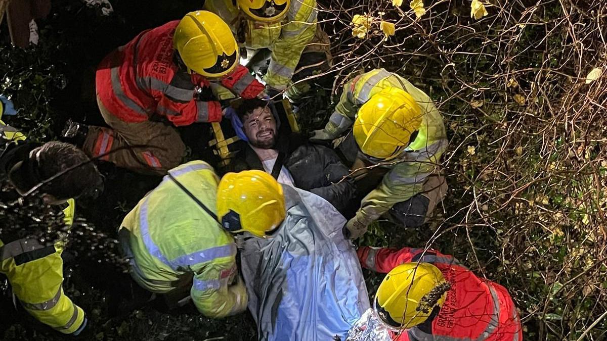 Eric Ham being carried on a stretcher after breaking his back in two places after falling from a bridge