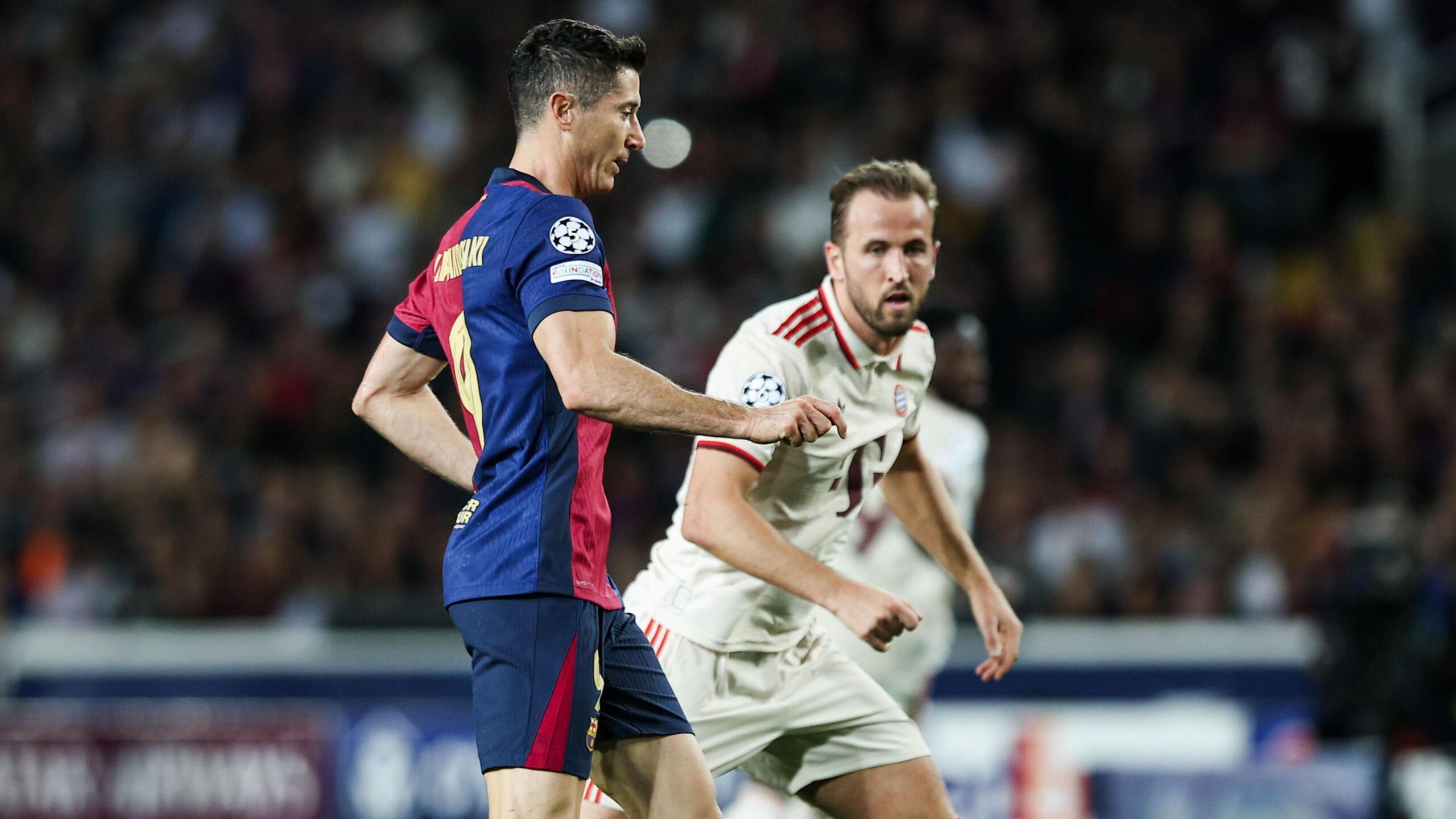 Robert Lewandowski and Harry Kane playing against each other in a match between Barcelona and Bayern Munich
