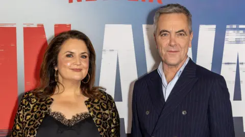 Getty Images Ruth Jones and James Nesbitt at the Run Away premier. Ruth wears a black cami top with lace detailing and a leopard print jacket. James wears a light blue shirt and a pinstripe, buttoned-up navy suit jacket